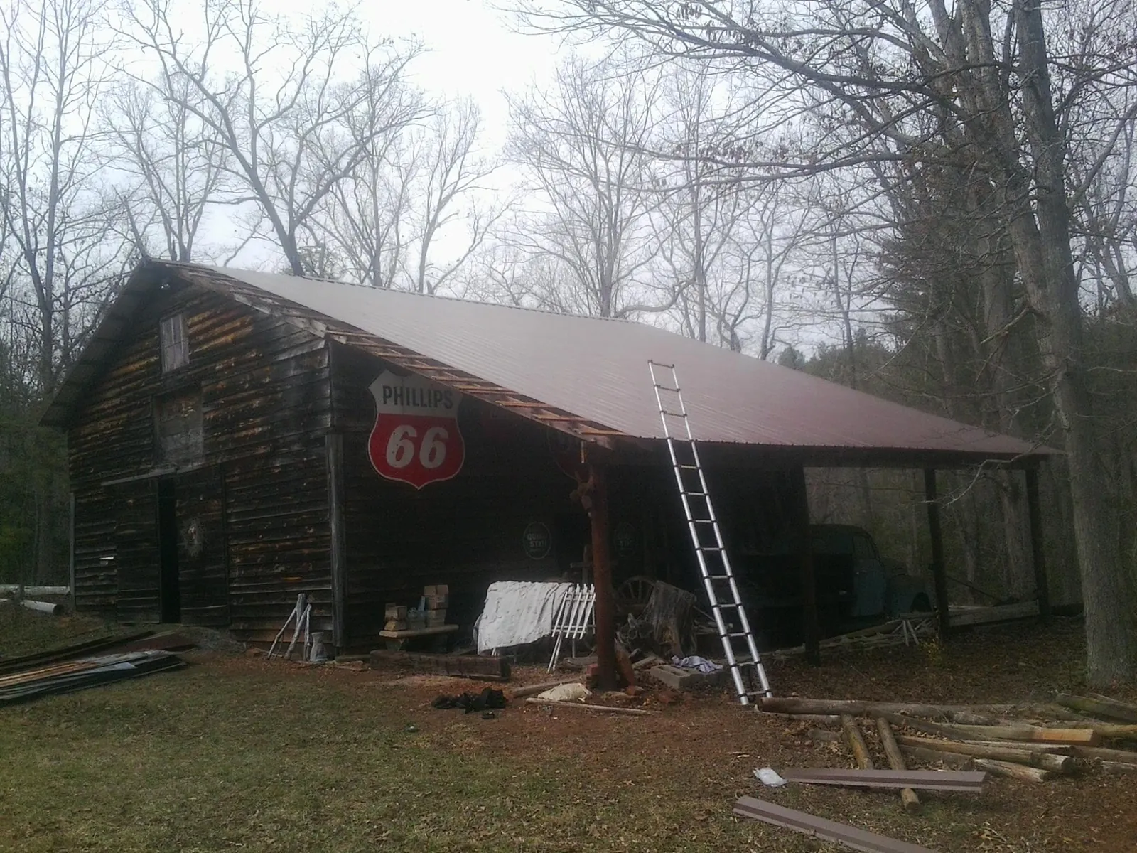 New metal roof on an open sided timber barn with a vintage sign in Ann Arbor